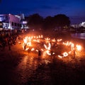 A beautiful, abstract scene of fire spinners in London at the bank of Thames. Nighttime performance.