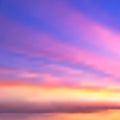 Beautiful abstract vector background of sunset or sunrise over the sea. Blurry haze of stripes of pink clouds against blue sky, Royalty Free Stock Photo
