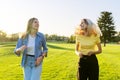 Beautiful active running young women, green lawns of the park at sunset