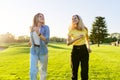 Beautiful active running young women, green lawns of the park at sunset