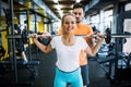 Beautiful active woman doing squats in gym