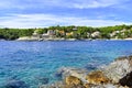 Beautiful Adriatic sea in Croatia. Blue lagoon  houses in green pines  rocky coast Royalty Free Stock Photo