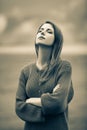 Beautiful adult girl in sweater at wheat field