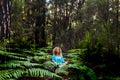 Beautiful adult lady do mindfulness exercises and yoga m editation sit down in the silence of the green nature forest - people Royalty Free Stock Photo