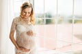 Beautiful adult pregnant woman. Waiting for the baby. Pregnancy. Care, tenderness, motherhood, childbirth. Royalty Free Stock Photo