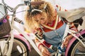Beautiful adult woman do diy repair and restore at home of a bike using coloured wool - concep tof people in indoor leisure