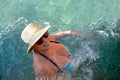 Beautiful adult woman in a straw hat bathes in Cleopatra`s pool Royalty Free Stock Photo