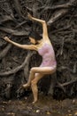 Active woman dancing with overturned tree roots in Manchester, Connecticut Royalty Free Stock Photo