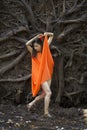 Active woman dancing with overturned tree roots in Manchester, Connecticut Royalty Free Stock Photo