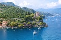 Beautiful aerial daylight view from top to boats on water, colorful houses and villas in Portofino town of Italy.
