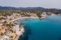 Beautiful aerial drone view shot of Peguera town on rocky Mediterranean cliff coast with cozy tranquil turquoise bays washed with Royalty Free Stock Photo