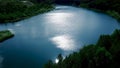 Beautiful aerial forest scene with green trees and a pond on sunny summer day. Stock footage. Flying over calm pond in Royalty Free Stock Photo