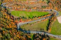 Beautiful aerial landscape of mountain forest road. Aerial view of curvy road in beautiful autumn forest