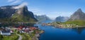 Beautiful aerial panorama of the blue sea surrounding the fishing village and rocky peaks Reine, Moskenes, Lofoten, Norway, sunny Royalty Free Stock Photo