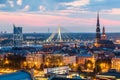 Beautiful aerial panorama of Riga center and Vansu bridge over Daugava river during amazing sunset. View of illuminated Riga city,