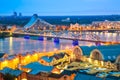 Beautiful aerial panorama of Riga. Railroad bridge over Daugava river and National library during amazing sunset. View of illumina