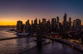 Beautiful aerial panoramic shot of downtown skyscrapers against golden sunset sky. Silhouettes of high rise office Royalty Free Stock Photo