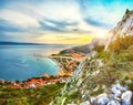 Beautiful aerial panoramic view of Cetina river, mountains and Old town Omis at sunset Royalty Free Stock Photo