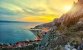 Beautiful aerial panoramic view of Cetina river, mountains and Old town Omis at sunset Royalty Free Stock Photo