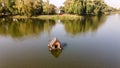 Beautiful aerial photo of the ducks at the wooden floating hut on the river