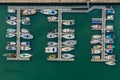 Beautiful aerial view of aligned columns of colorful boats in the water in Arbroath harbor, Scotland