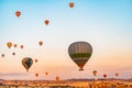 Beautiful aerial view of colorful hot air balloons flying over Cappadocia, Turkey. Royalty Free Stock Photo