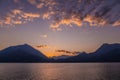 Beautiful aerial view of the famous Como Lake on purple sunset. Clouds reflecting in calm waters of the lake with Alp mountain Royalty Free Stock Photo