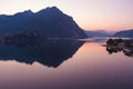 Beautiful aerial view of the famous Como Lake on purple sunset. Mountains reflecting in calm waters of the lake with Alp mountain Royalty Free Stock Photo