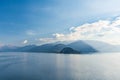 Beautiful aerial view of the famous Como Lake on sunny summer day. Clouds reflecting in calm waters of the lake with Alp mountains Royalty Free Stock Photo