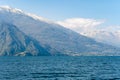 Beautiful aerial view of the famous Como Lake on sunny summer day. Clouds reflecting in calm waters of the lake with Alp mountains Royalty Free Stock Photo