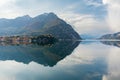 Beautiful aerial view of the famous Como Lake on sunny summer day. Clouds reflecting in calm waters of the lake with Alp mountains Royalty Free Stock Photo