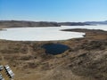 Beautiful aerial view of the frozen bay of Lake Baikal and Lake Nuku Nur in the shape of a heart in spring.