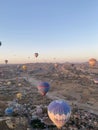 Beautiful aerial view of hot air balloons flying over Cappadocia at soft sunset