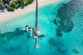 Beautiful aerial view of Maldives shore, jetty villa seaplane top view, wooden boat Dhoni and tropical beach