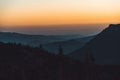 Beautiful aerial view of an orange sunset over mountains up in the hills Royalty Free Stock Photo