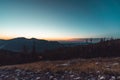 Beautiful aerial view of an orange sunset over mountains up in the hills Royalty Free Stock Photo