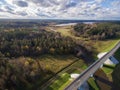 Beautiful aerial view of road bridge over the river surrounded by forest