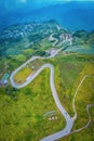 Beautiful aerial view of road between green and yellow pine tree forest in Thailand. Car moving on road Royalty Free Stock Photo