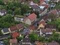 Aerial view of village Honau, Swabian Alb, with main road, old buildings and cars passing by in late spring with green trees.