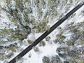 Beautiful aerial view of snow covered pine forests and a road winding among trees. Rime ice and hoar frost covering trees. Scenic Royalty Free Stock Photo