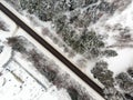 Beautiful aerial view of snow covered pine forests and a road winding among trees. Rime ice and hoar frost covering trees. Scenic Royalty Free Stock Photo