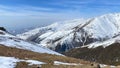 Beautiful aerial view of the snowy mountain valley. Mountain landscape. The amazing nature of Kyrgyzstan. Blue sky, rocks and Royalty Free Stock Photo