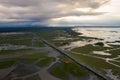 Beautiful aerial view of traffic on elevated road and tollway surrounded green rice fields Royalty Free Stock Photo