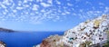 Beautiful panoramic aerial view of white washed villas against blue sky, Santorini, Greece Royalty Free Stock Photo