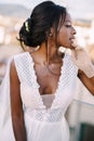 Beautiful African American bride in a white wedding dress, touches her face in vintage gloves. Fine-Art Wedding in Royalty Free Stock Photo