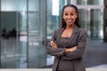 Happy African American female company leader CEO boss executive standing in front of company building Royalty Free Stock Photo