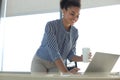 Beautiful african american business woman in smart casual wear working on laptop in the office Royalty Free Stock Photo