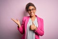 Beautiful african american businesswoman wearing jacket and glasses over pink background Showing palm hand and doing ok gesture Royalty Free Stock Photo