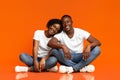 Beautiful african american couple sitting on floor and hugging Royalty Free Stock Photo