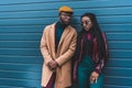 beautiful african american couple in stylish outfit posing together